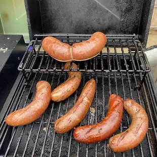 Fresh made sausages on the smoker