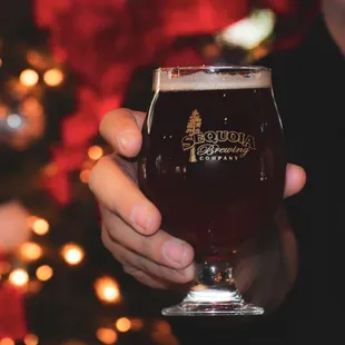 a man holding a glass of beer