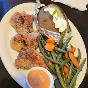 Pork tenderloin with baked potatoe and veggies