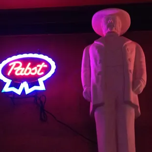 a statue of a man in a white suit and hat