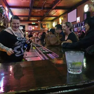 a group of people sitting at a bar