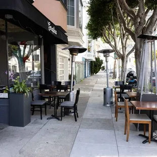 tables and chairs on a sidewalk