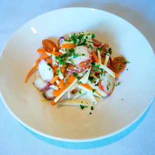 a white bowl of food on a table