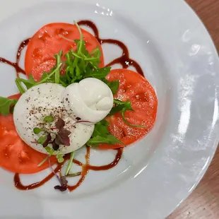 a plate of food with tomato and mozzarella