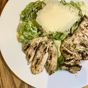 grilled chicken and lettuce on a white plate