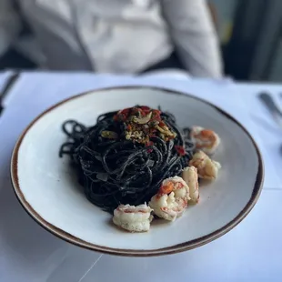 Squid ink spaghetti with prawns