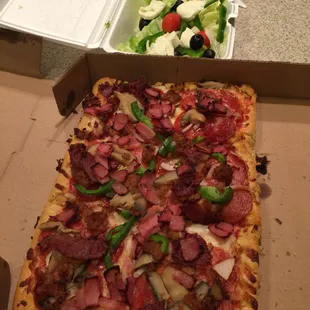 a salad and a pizza box