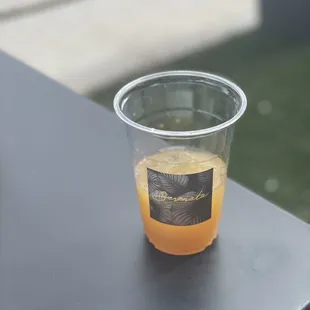 a glass of orange juice on a table