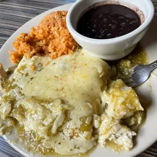 Chicken enchiladas with rice and beans.