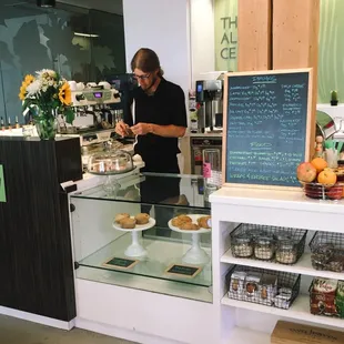 a man standing behind the counter