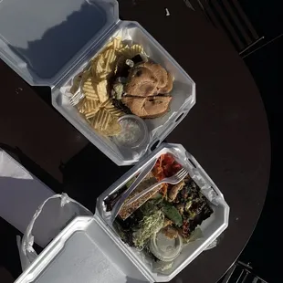 two takeout containers of food