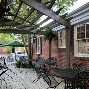 a patio with tables and chairs