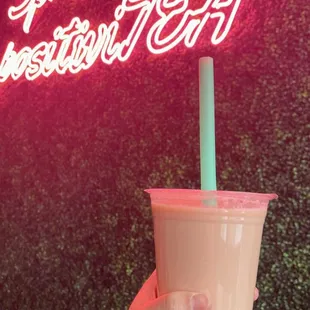 a hand holding a cup