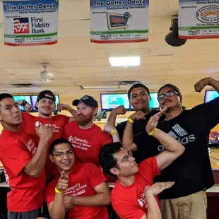 Charity bowling event movers flexing