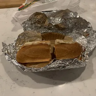 a half eaten sandwich in foil