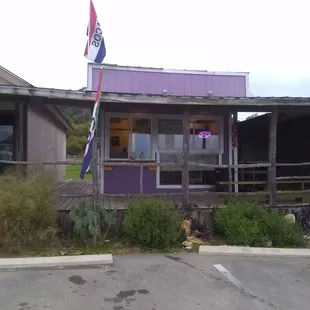 Sergio's Tacos - small storefront painted purple. Some seating outside.