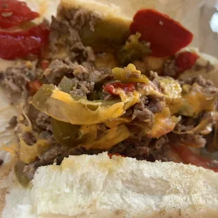 HANNIBAL cheesesteak  Sirloin, grilled onions, hot cherry peppers, sweet peppers, tomatoes, pickles &amp; cheddar cheese .