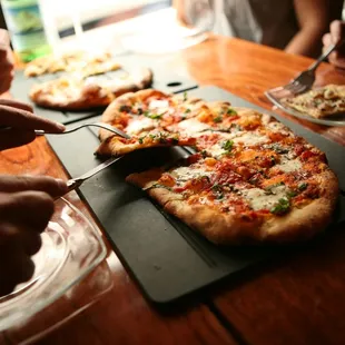 Group eating pizza at a table at Serious Pie - Downtown Seattle location