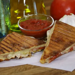 Pizzini: Pepperoni &amp; mozzarella sandwiched between two layers of pizza dough. Served w/homemade marinara sauce!