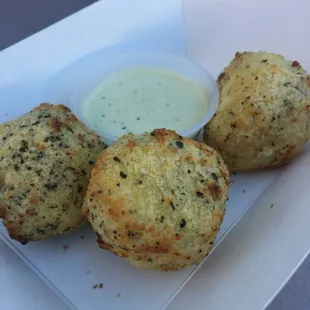 Arancini: 3 cheese risotto rice balls w/Basil creme.