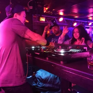 a dj mixing music in a nightclub