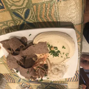 a plate of food with pita chips and dip
