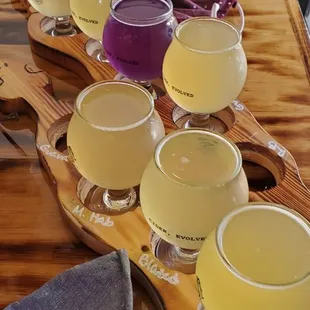 a variety of ciders on a wooden board