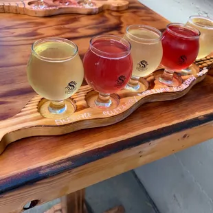 Tasting flight on wood planks shaped like serpents