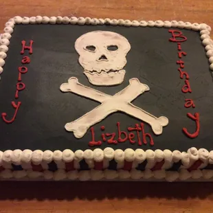 a birthday cake decorated with a skull and crossbones