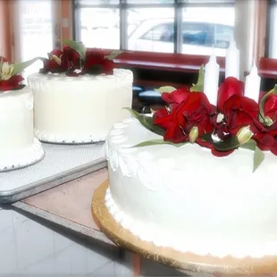 two cakes with candles and flowers