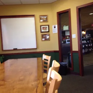 Separate room with 10 seat conference table and white board