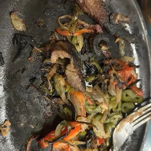 You can see the fajitas are burnt. This should not be served to people, the kitchen staff should be reprimanded and the management as well.