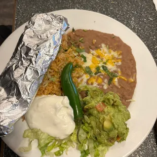 Rice, refried beans, guacamole, serrano pepper, shredded lettuce with sour cream