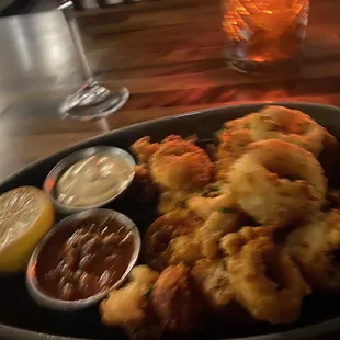 a plate of fried calamails and dippings