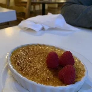 Creme brulee with fresh raspberries.
