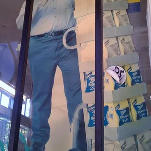 ows a man standing in front of a poster