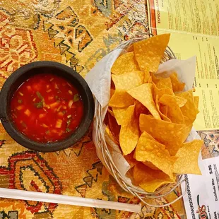 a bowl of salsa and chips