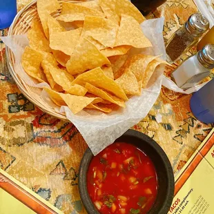 a bowl of tortilla and a bowl of salsa