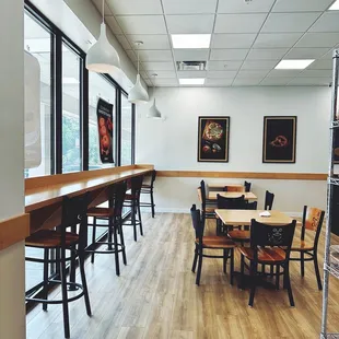 a dining area with tables and chairs