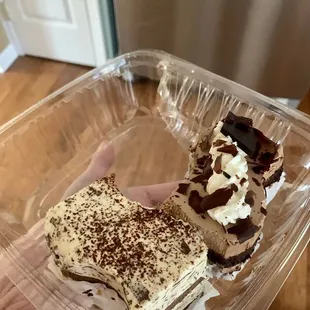 a hand holding a piece of cake