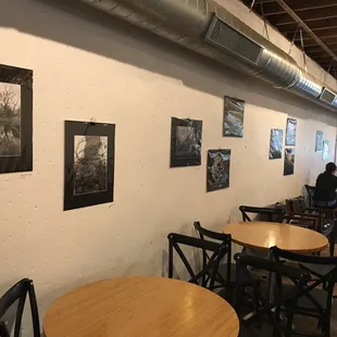 people sitting at tables in a coffee shop