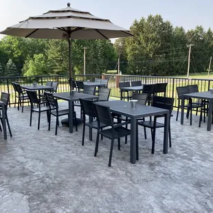 a patio with tables and umbrellas