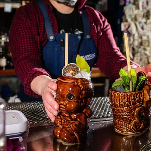 a bartender preparing cocktails at a bar
