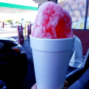 a hand holding a cup of shaved ice
