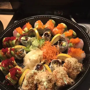 a plate of sushi and rolls