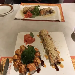 two plates of sushi and a glass of beer
