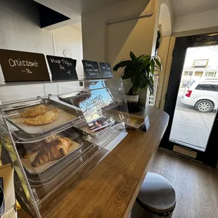 a bakery counter with a variety of pastries