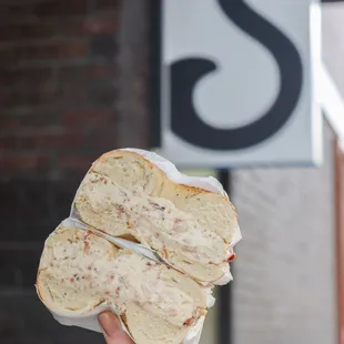  person holding a sandwich in their hand