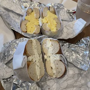 wo sandwiches on tin foil on a table