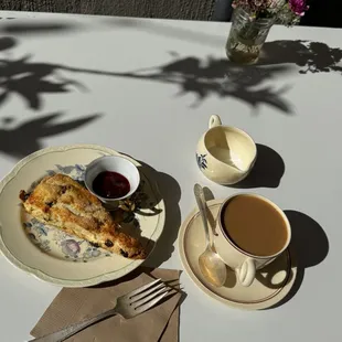 Perfect scone (w/teeny china cup of plum jam), coffee and cream
